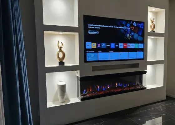 Cinewall met sfeerhaard, soundbarvak en verlichte vakken, voorbeeld van cinewallcenter